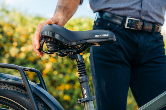 Man holding the comfort saddle on a electric eBike from Denago.