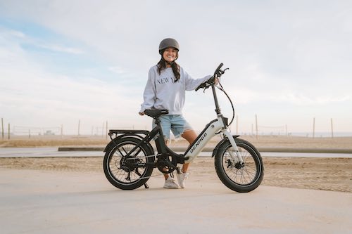 woman with Denago Folding 1 eBike at the ocean