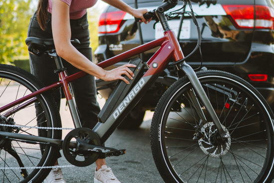 Woman installing the semi-integrated eBike battery into the Denago City Model 1 Top Tube eBike.